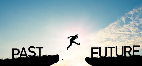 Go ahead and continuously improvement concept, silhouette man jump on a cliff from past to future with cloud sky background.